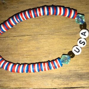 This is a USA red white and blue clay bead bracelet with a lobster clasp.